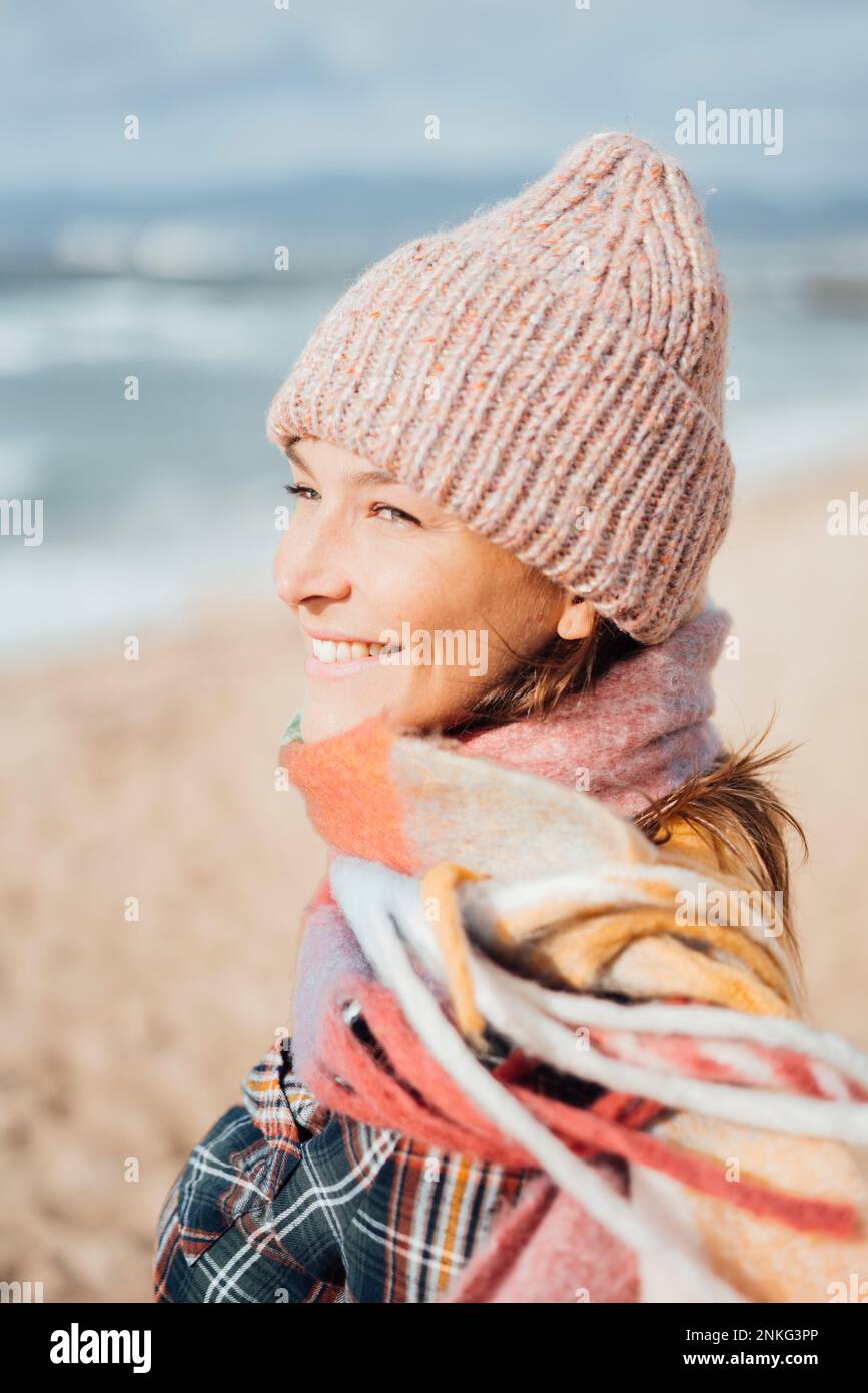Happy woman wearing knit hat and scarf Stock Photo