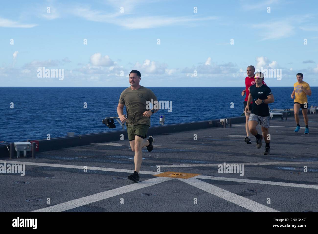 U.S. Marines with Battalion Landing Team 2/5, 31st Marine Expeditionary Unit, and U.S. Navy Sailors with USS Miguel Keith (ESB-5), take part in a 5 kilometer run aboard ESB-5, in the Philippine Sea, Aug. 14, 2022. The Marines and Sailors conducted a 5 kilometer run in honor of Lance Cpl. Miguel Keith. The 31st MEU is operating aboard ships of Amphibious Assault Ship USS Tripoli Amphibious Ready Group in the 7th fleet area of operations to enhance interoperability with allies and partners and serve as a ready response force to defend peace and stability in the Indo-Pacific region. Stock Photo