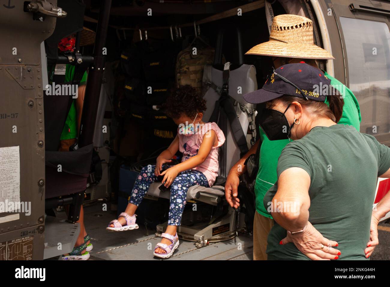 A child sits in a Sikorsky HH-60M MEDEVAC Black Hawk Helicopter during the 2022 Kaneohe Bay Air Show, Marine Corps Air Station Kaneohe Bay, Marine Corps Base Hawaii, Aug. 14, 2022. The air show provided an opportunity for MCBH to foster positive relationships with the local community, while providing a unique experience to the public. The Kaneohe Bay Air Show, which contained aerial performances, static displays, demonstrations and vendors, was designed to celebrate MCBH’s longstanding relationship with the local community. Stock Photo