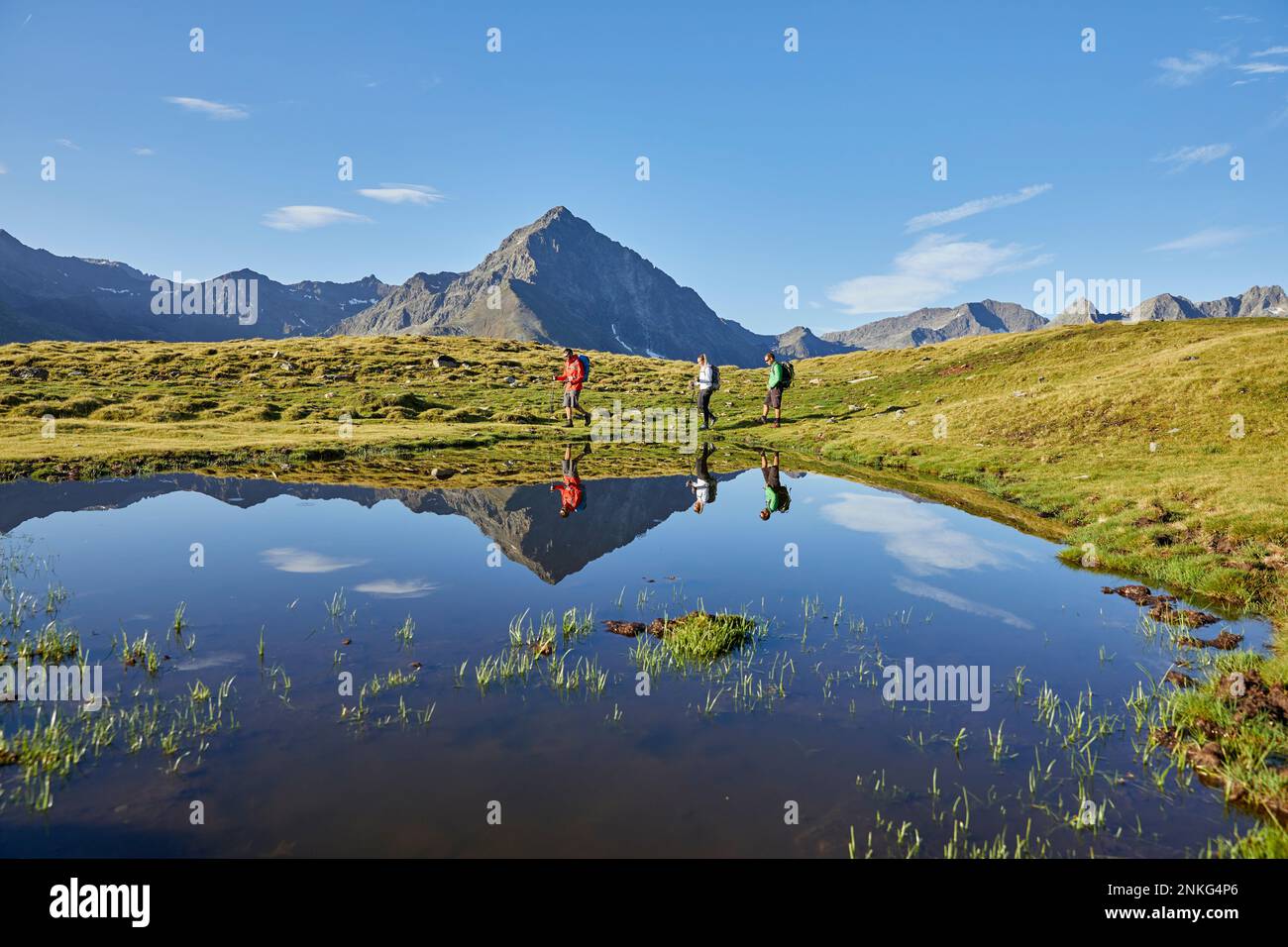 Group hikers passing small alpine lake hi-res stock photography and ...