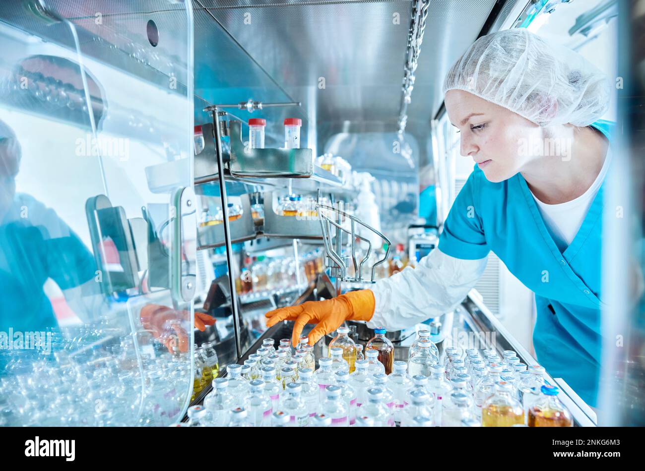 Female scientist working in cleanroom of a microbiological lab Stock Photo