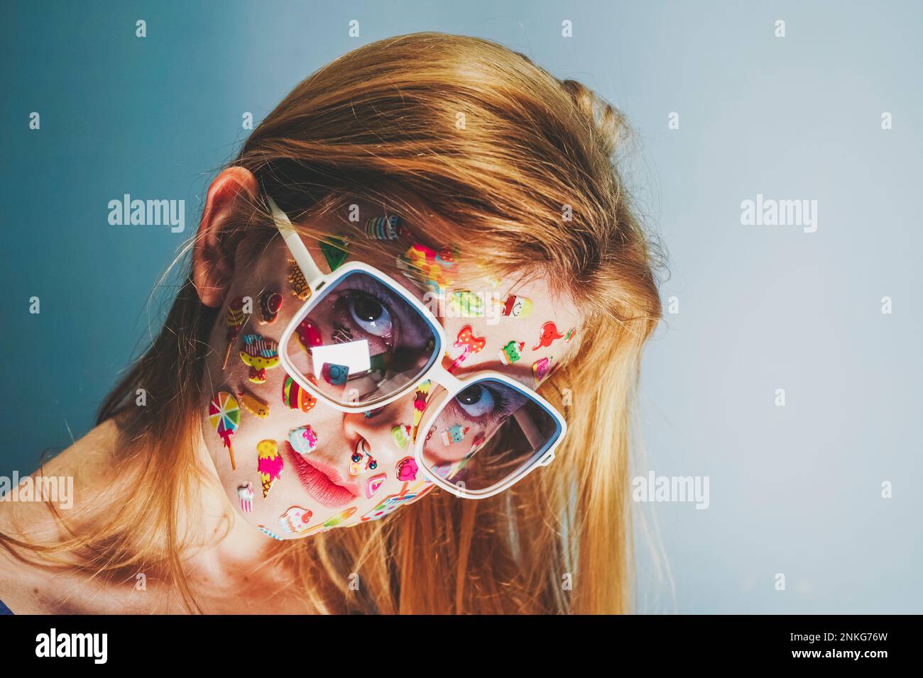 Blond woman with stickers over face wearing sunglasses Stock Photo Alamy