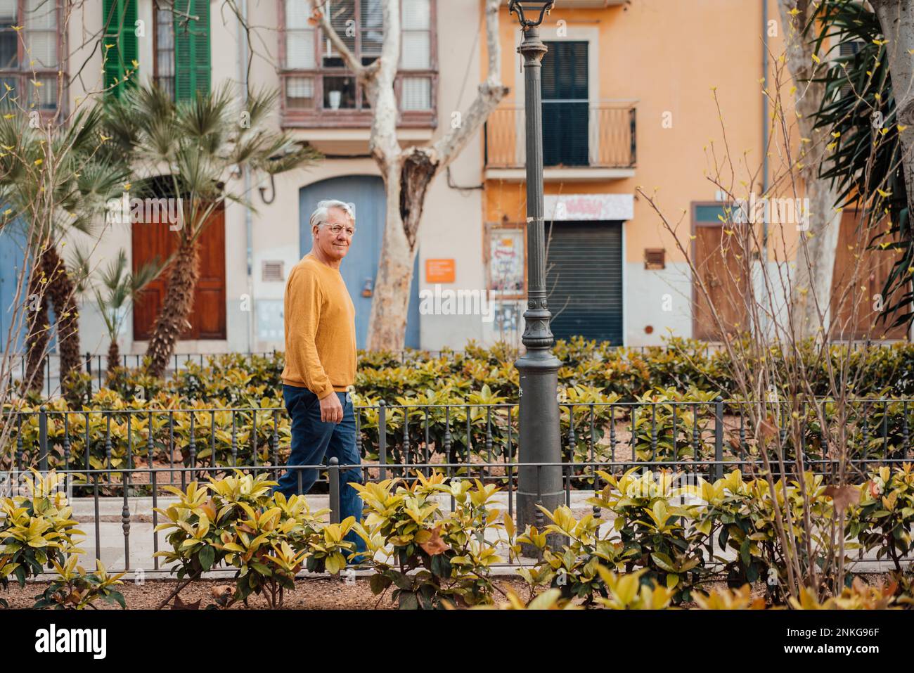 Senior man walking amidst hi-res stock photography and images - Alamy