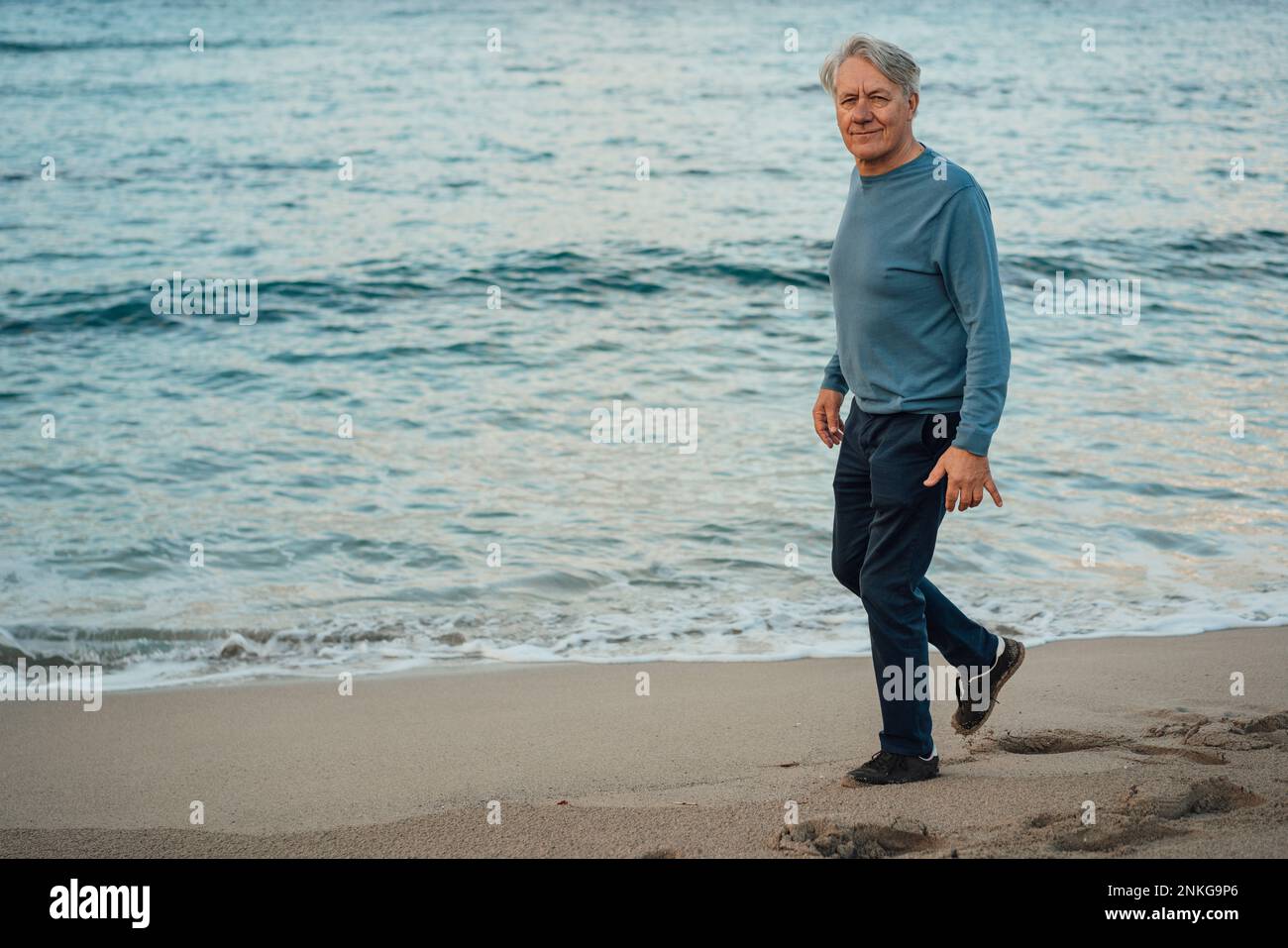 Senior male walking side view hi-res stock photography and images - Alamy