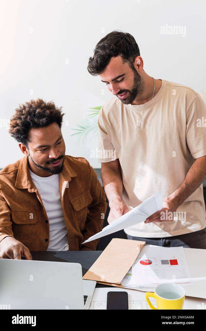 Businessmen having discussion over documents at office Stock Photo