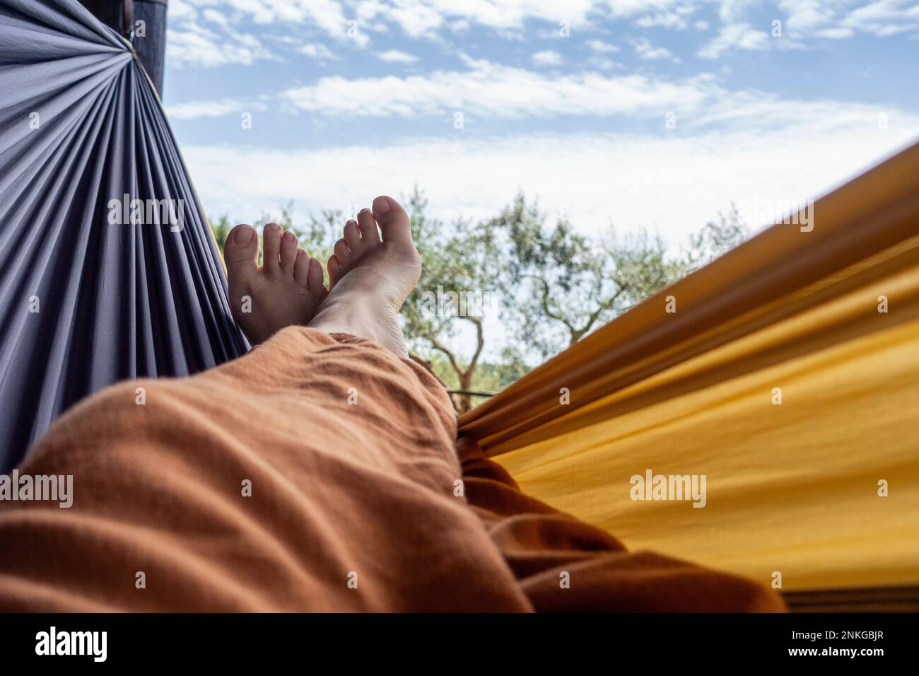 Mature woman relaxing in hammock Stock Photo - Alamy