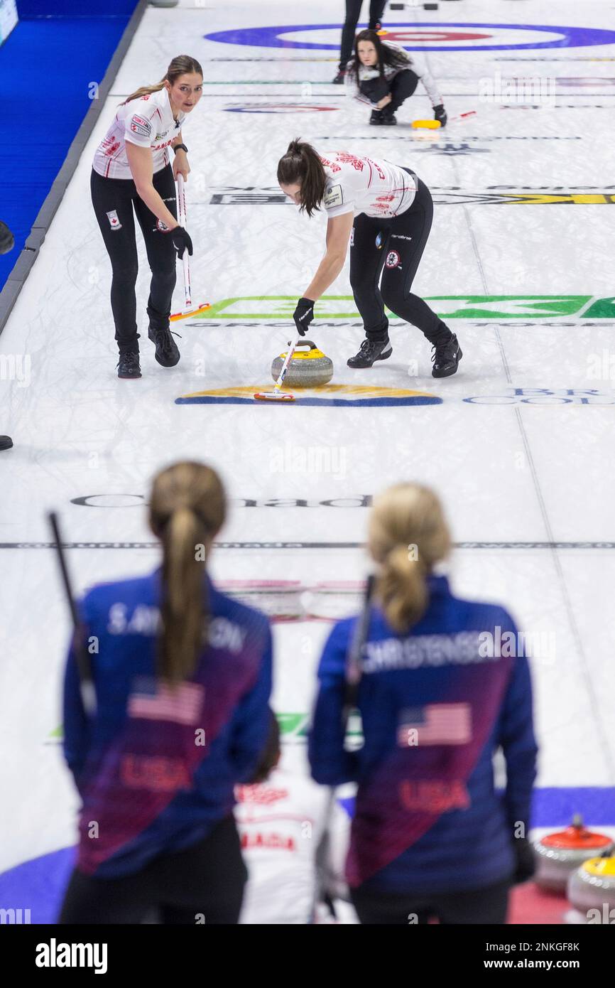 Canada lead Briane Meilleur, middle left, and second Shannon Birchard sweep in front of a stone as skip Kerri Einarson looks on while United States third Sarah Anderson, bottom left, and skip