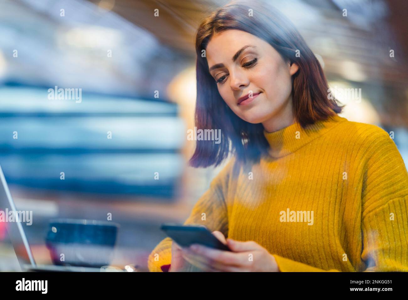 Businesswoman using smart phone in cafe Stock Photo