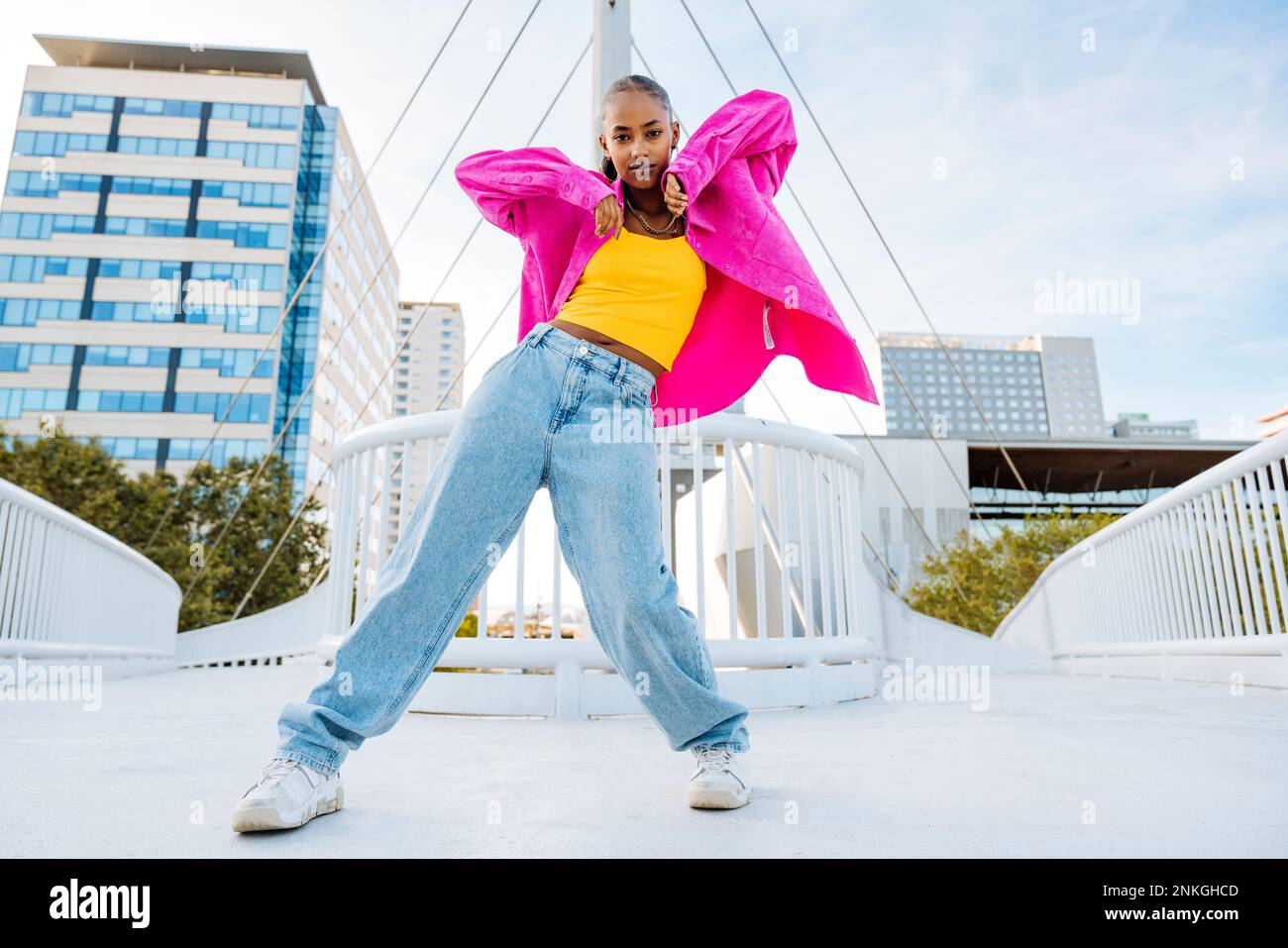 Confident young dancer breakdancing on footbridge Stock Photo