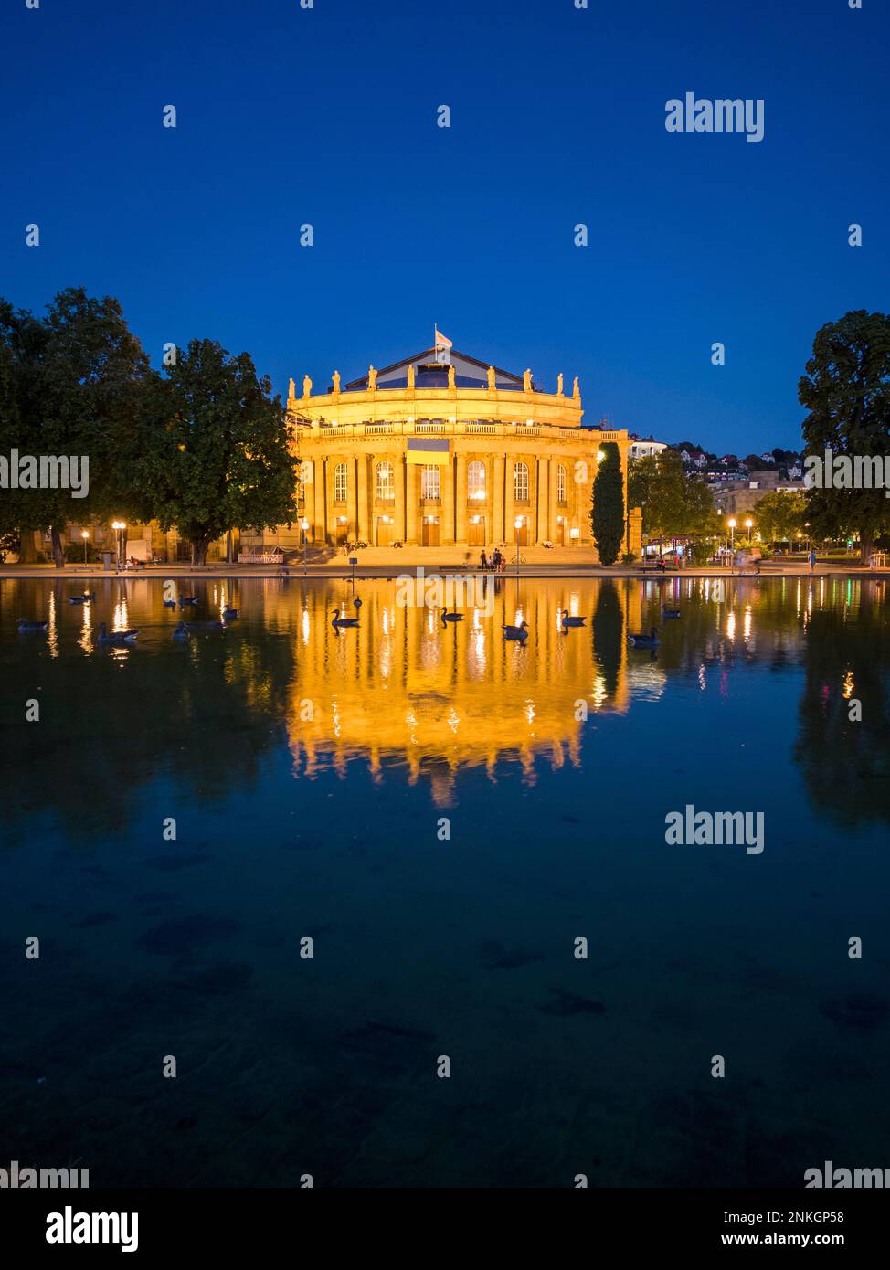 Reflection of Stuttgart State Theatre reflecting in water at night, Stuttgart, Germany Stock Photo