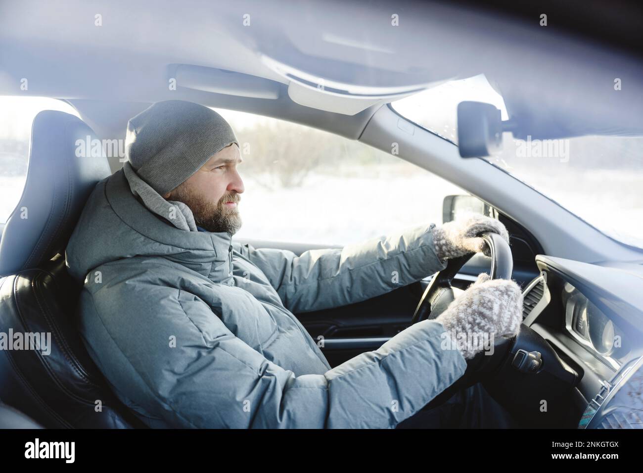 Man wearing knit hat driving car Stock Photo