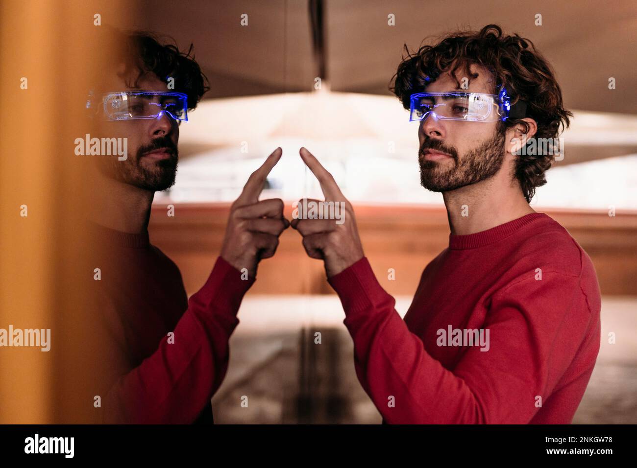 Man wearing smart eyeglasses using touch screen in underground walkway