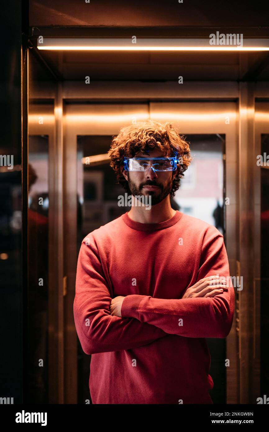 Man wearing smart glasses standing in elevator Stock Photo