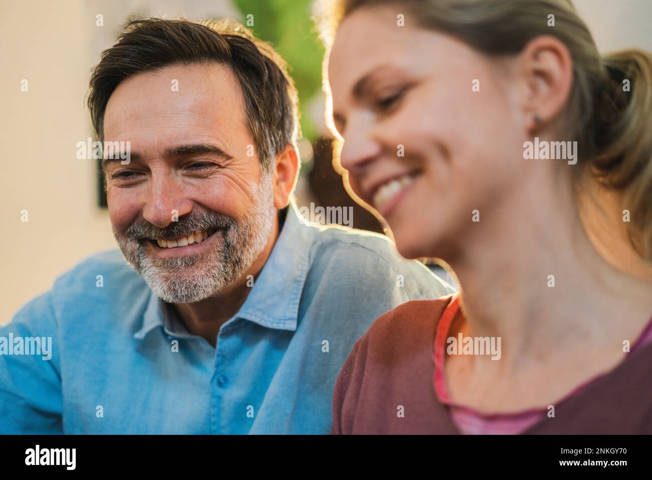 Happy mature man by wife at home Stock Photo