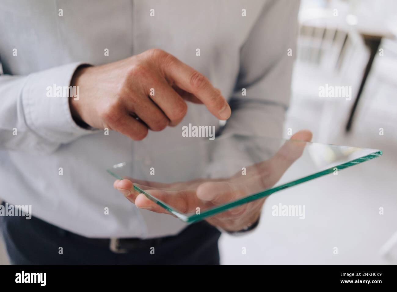Businessman using futuristic transparent tablet PC Stock Photo