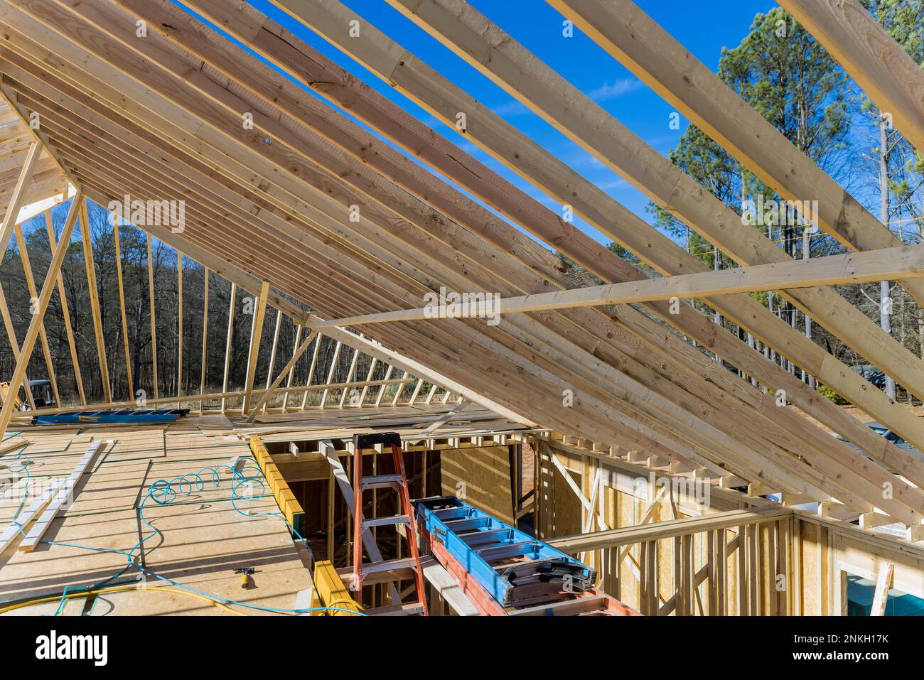 Wooden roof framework from trusses was constructed as part construction of new beam stick to home Stock Photo