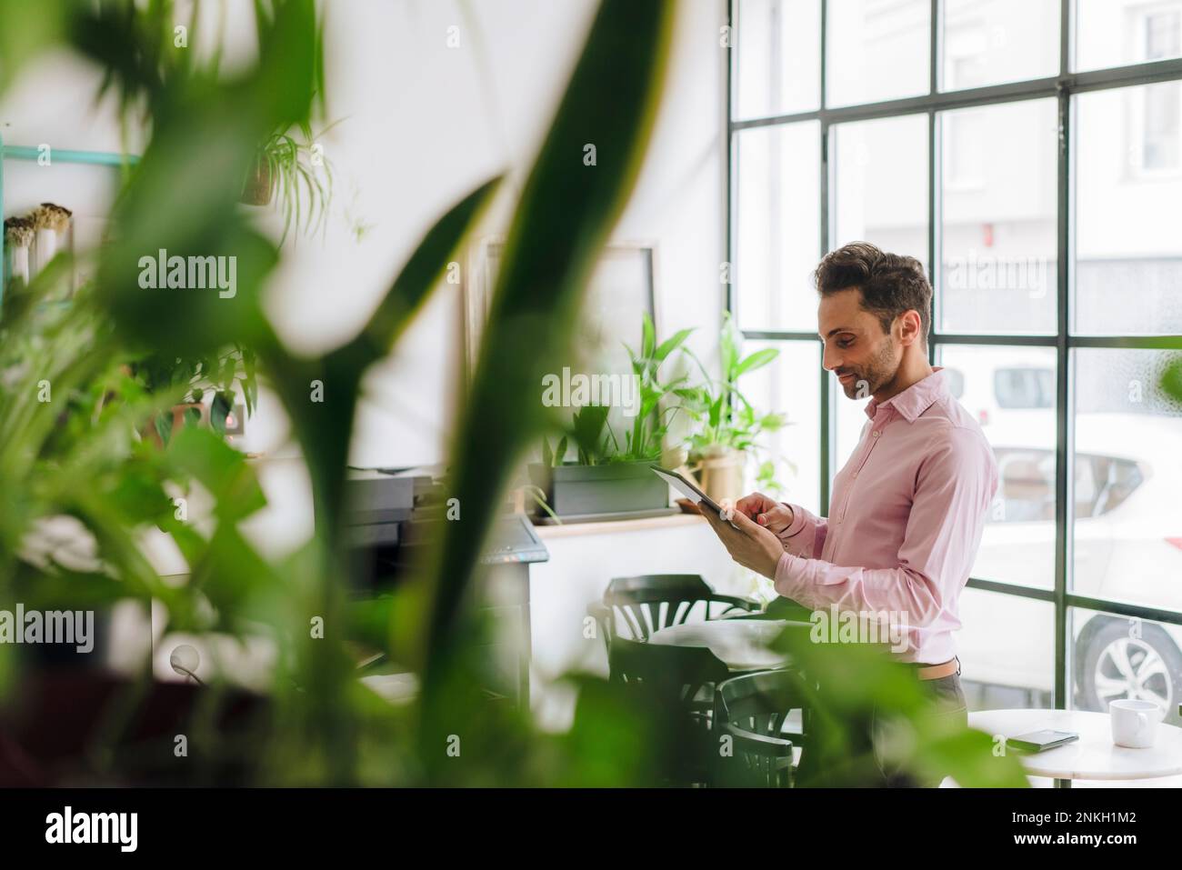Mature businessman working on tablet PC in office Stock Photo
