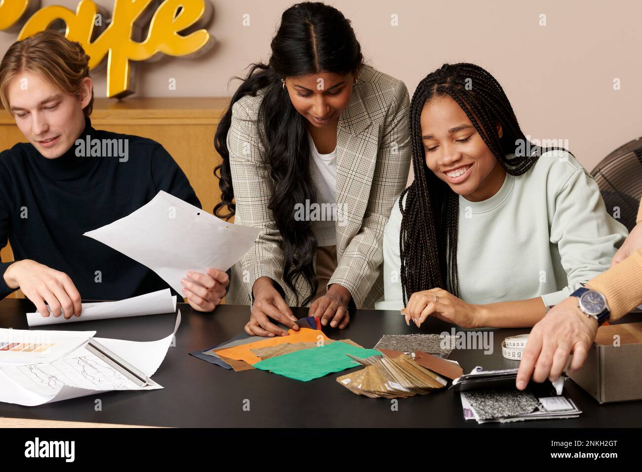 Multiracial fashion designers working together at studio Stock Photo
