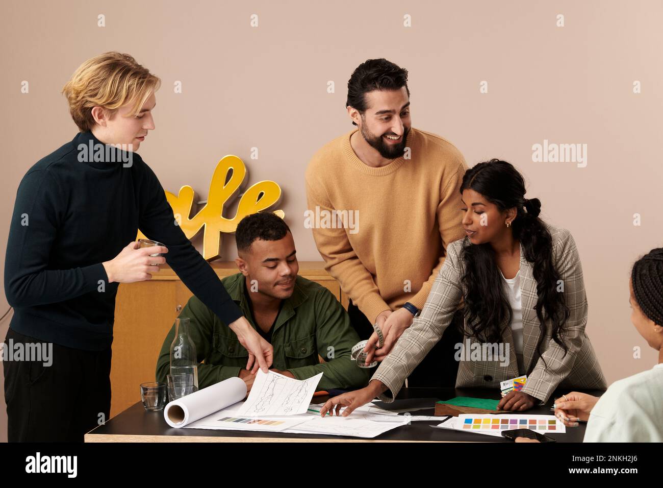 Multiracial fashion designers working together in studio Stock Photo