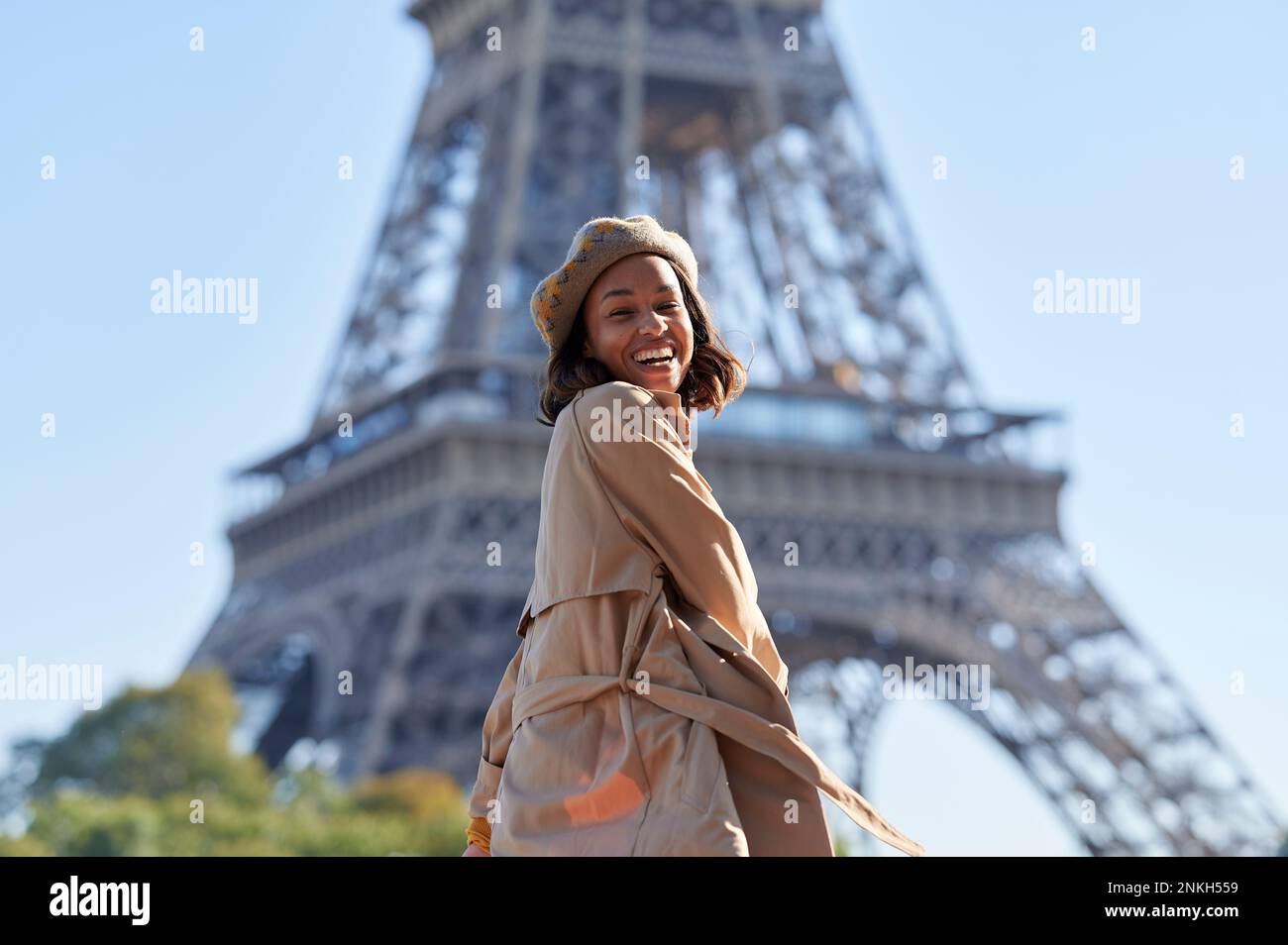 Happy young woman enjoying in front of Eiffel tower, Paris, France Stock Photo