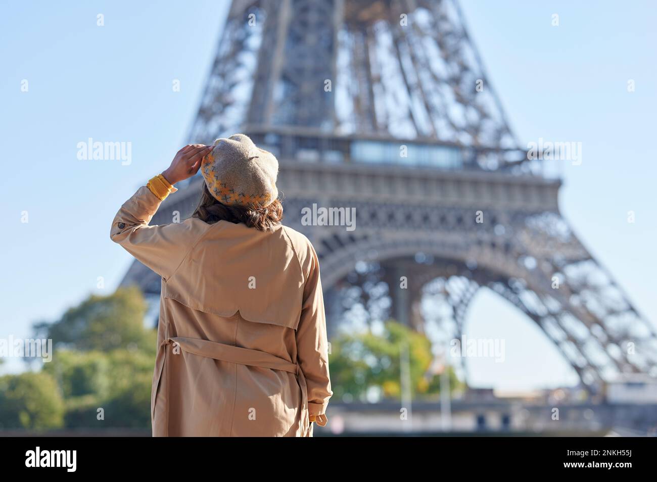 Woman wearing beret looking at Eiffel tower, Paris, France Stock Photo