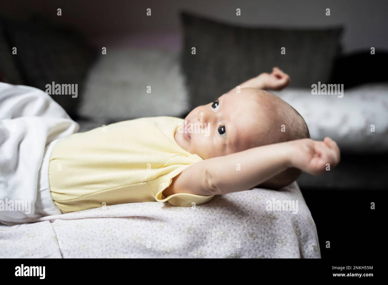 Cute baby boy stretching arms lying on sofa Stock Photo Alamy