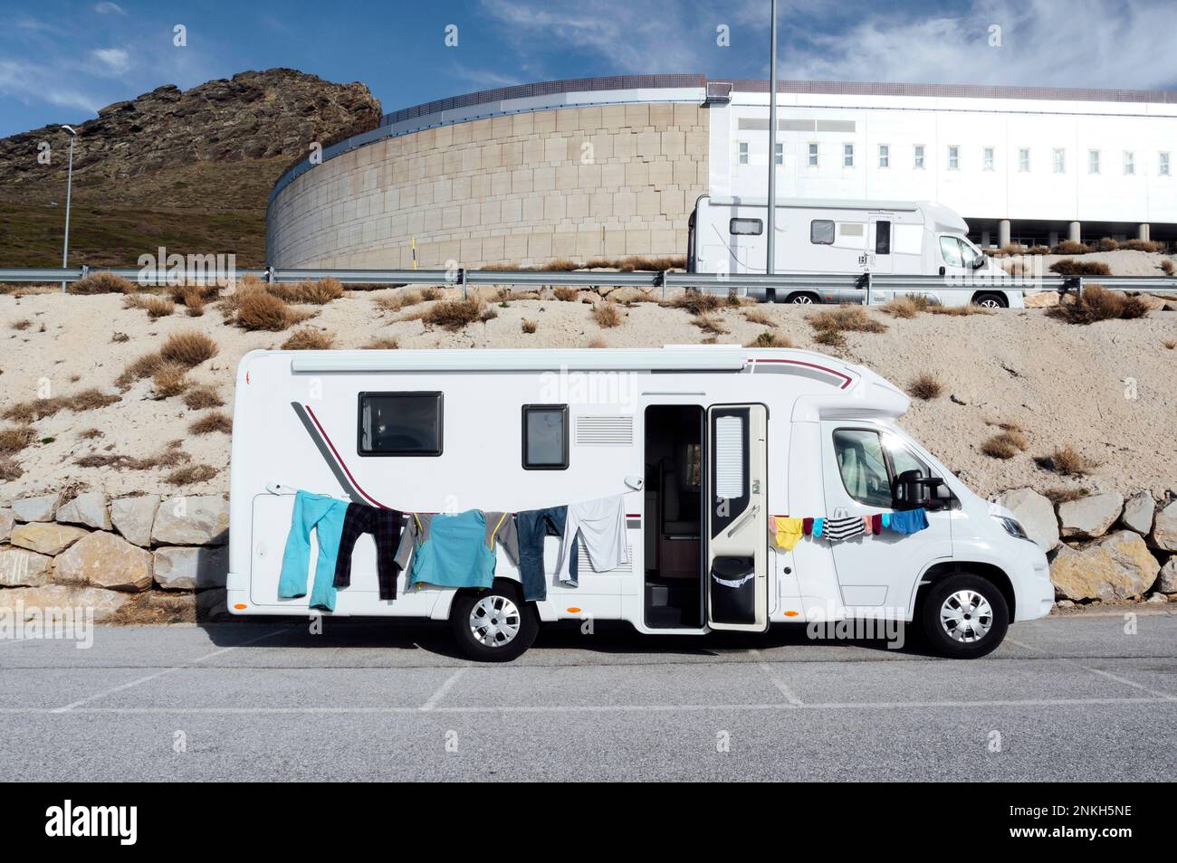 Clothes hanging on clothesline of camper van at sunny day Stock Photo