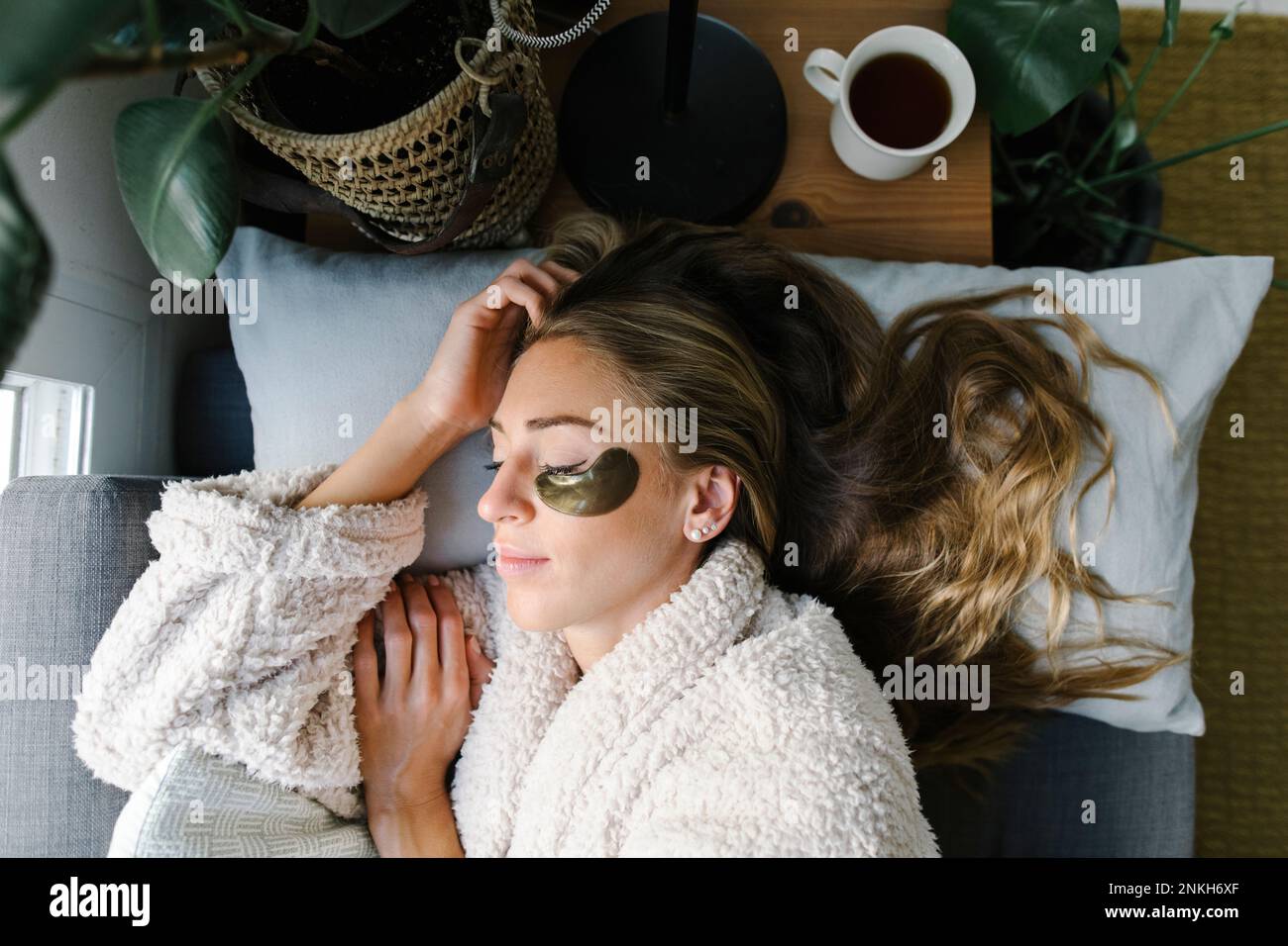 Woman with under eyes patch sleeping on bed at home Stock Photo Alamy