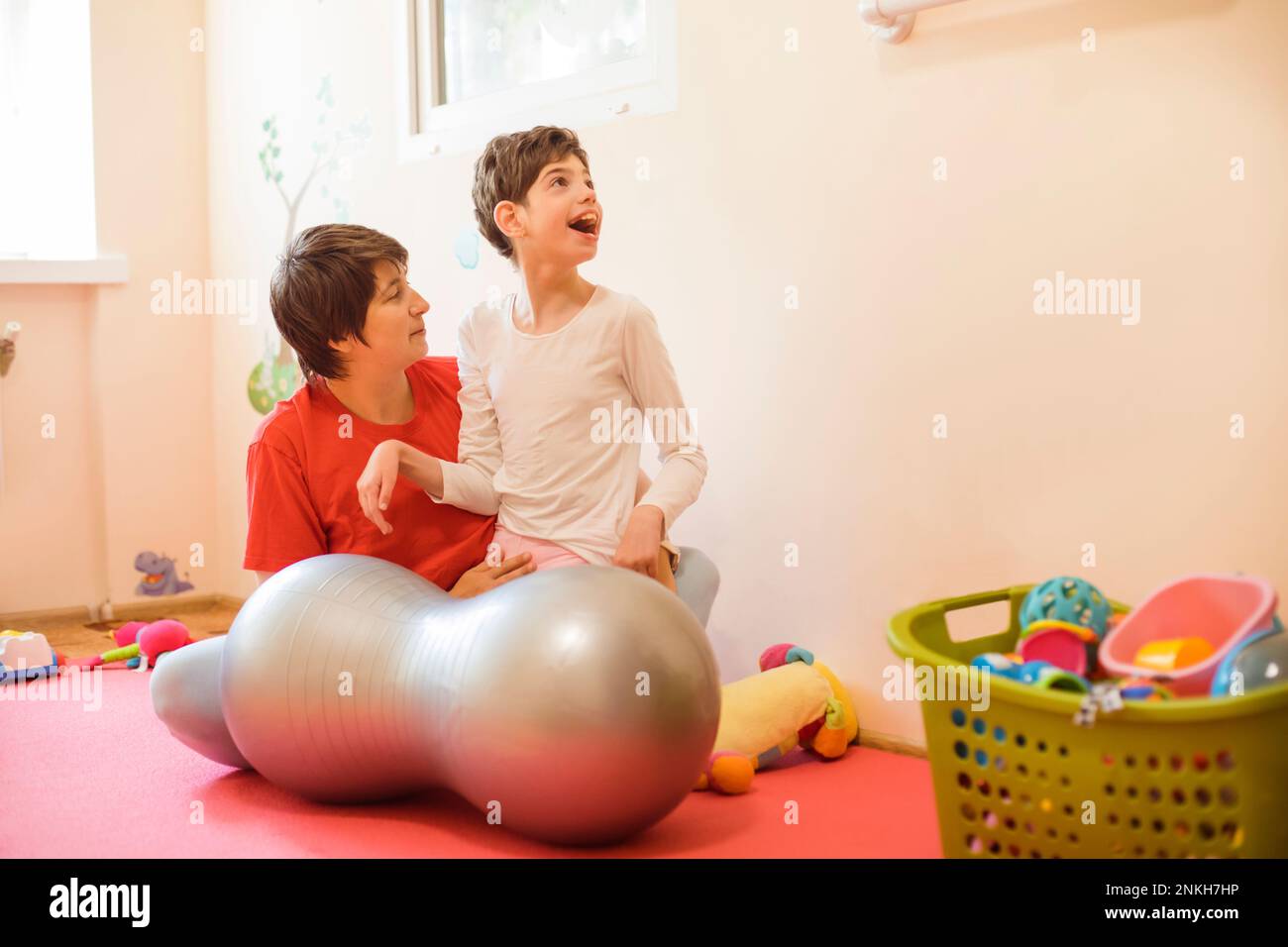 Physical therapist and girl with disability playing in rehabilitation centre Stock Photo Alamy