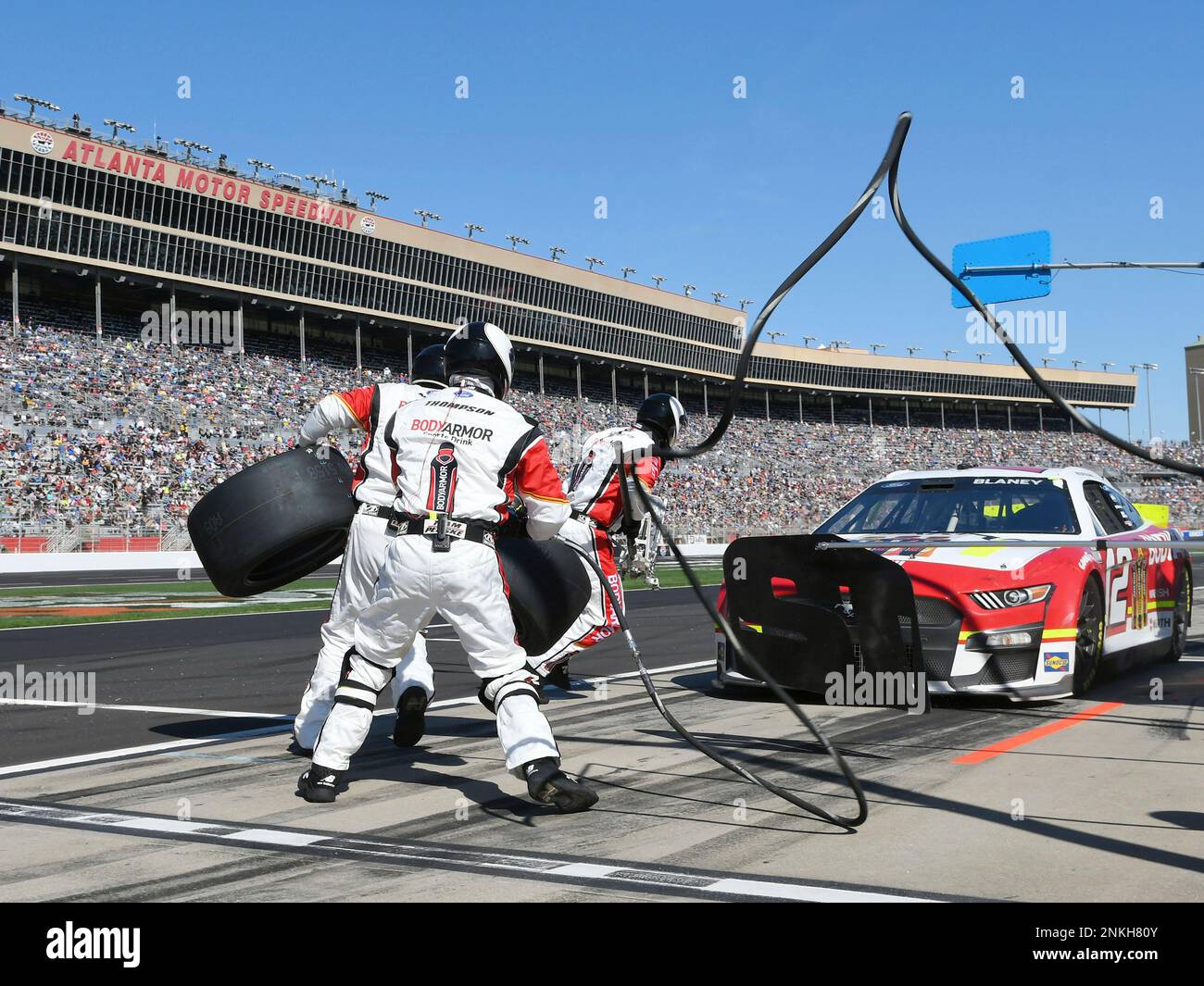 ATLANTA, GA MARCH 20 Crew members sprint onto pit road to service the car of Ryan Blaney (12