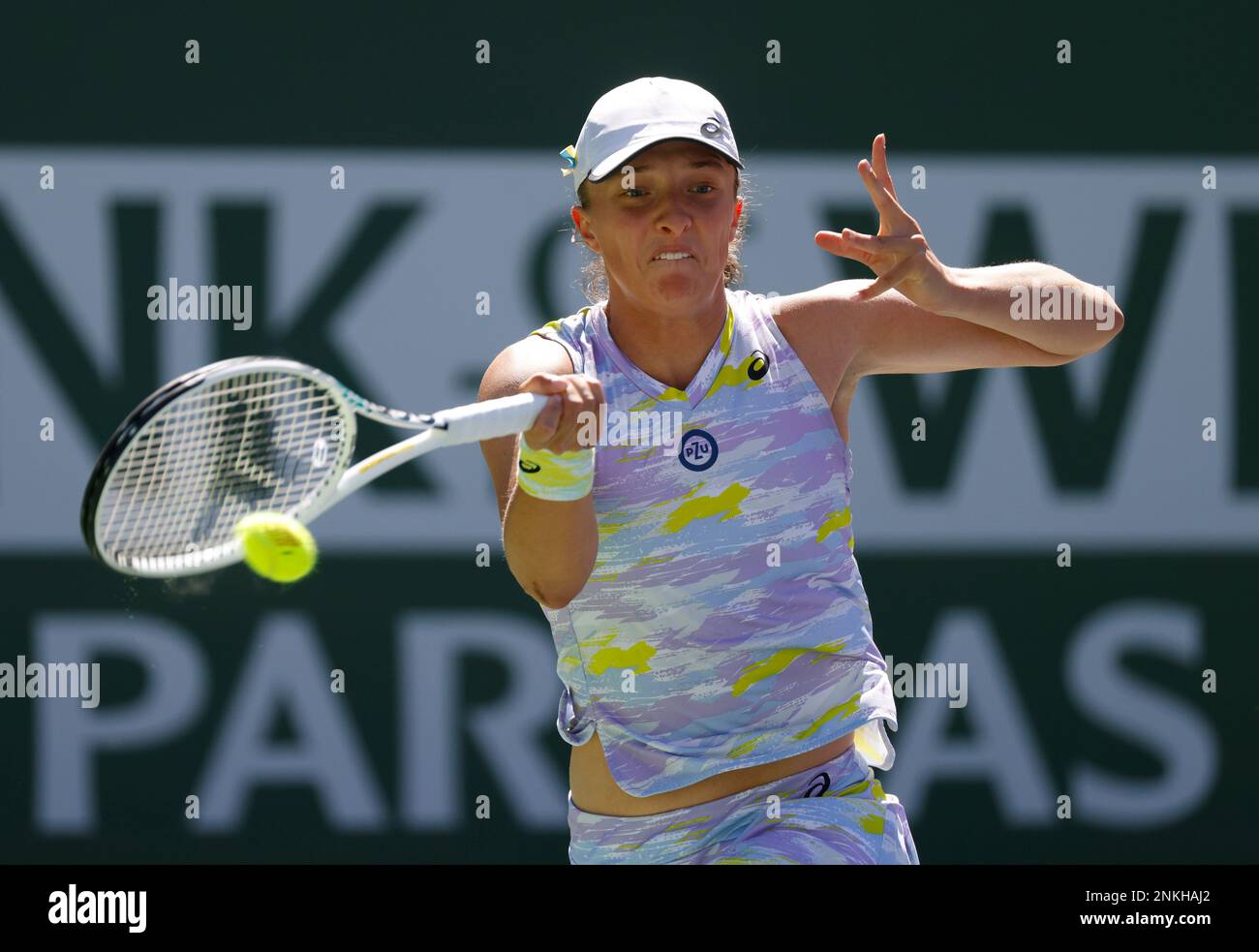 March 20, 2022 Iga Swiatek of Poland returns a shot against Maria Sakkari of Greece in the womens singles finals of the 2022 BNP Paribas Open at Indian Wells Tennis Garden in