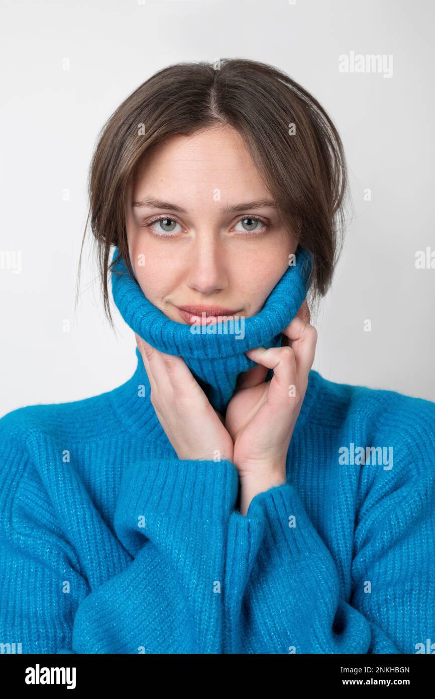 Confident woman wearing turtleneck against white background Stock Photo ...