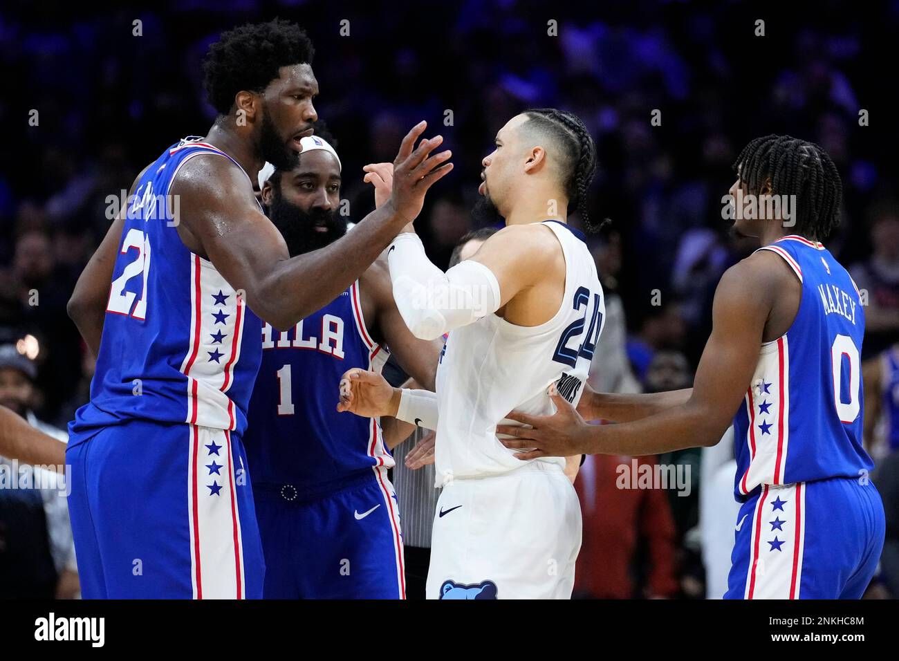 Philadelphia 76ers' Joel Embiid, left, and Memphis Grizzlies' Dillon Brooks jostle during the
