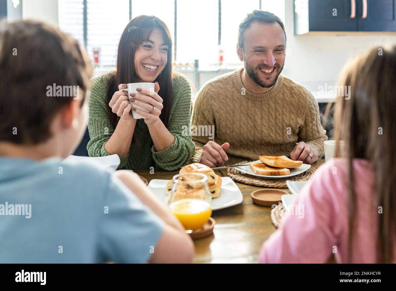 Happy family together having breakfast at table Stock Photo - Alamy