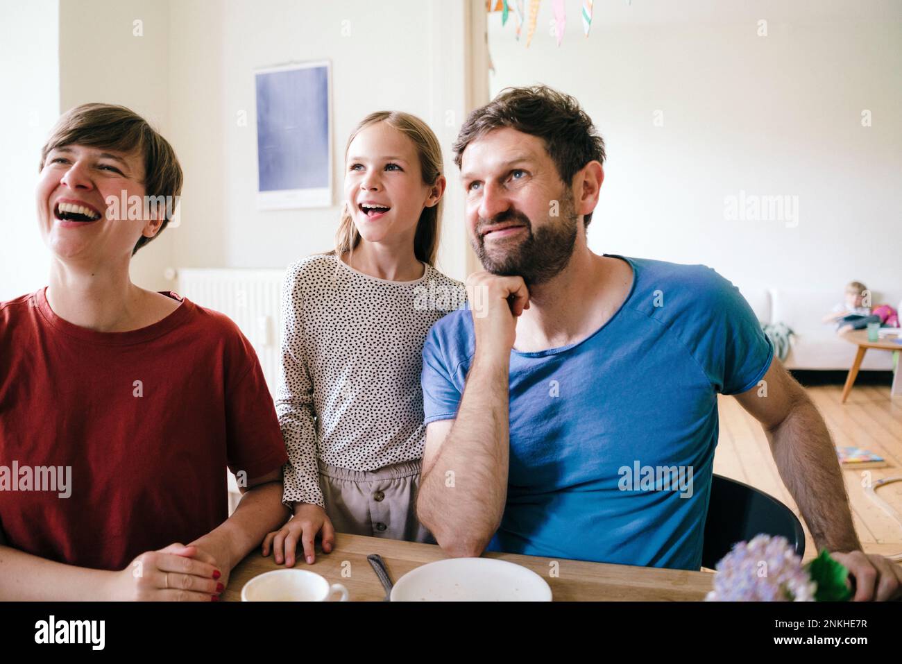 Happy family watching TV sitting at home Stock Photo
