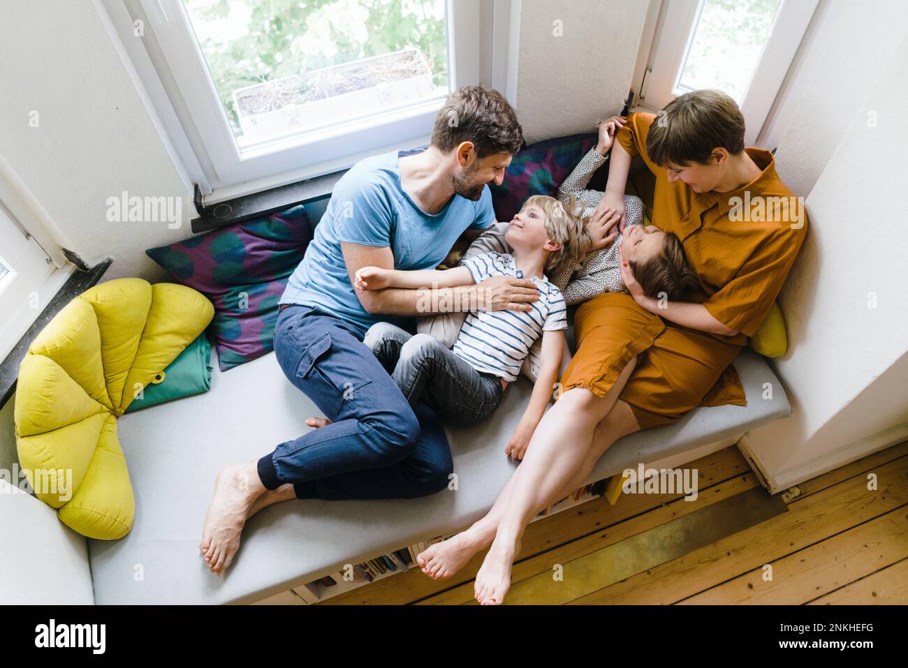 Parents spending leisure time with son and daughter at home Stock Photo