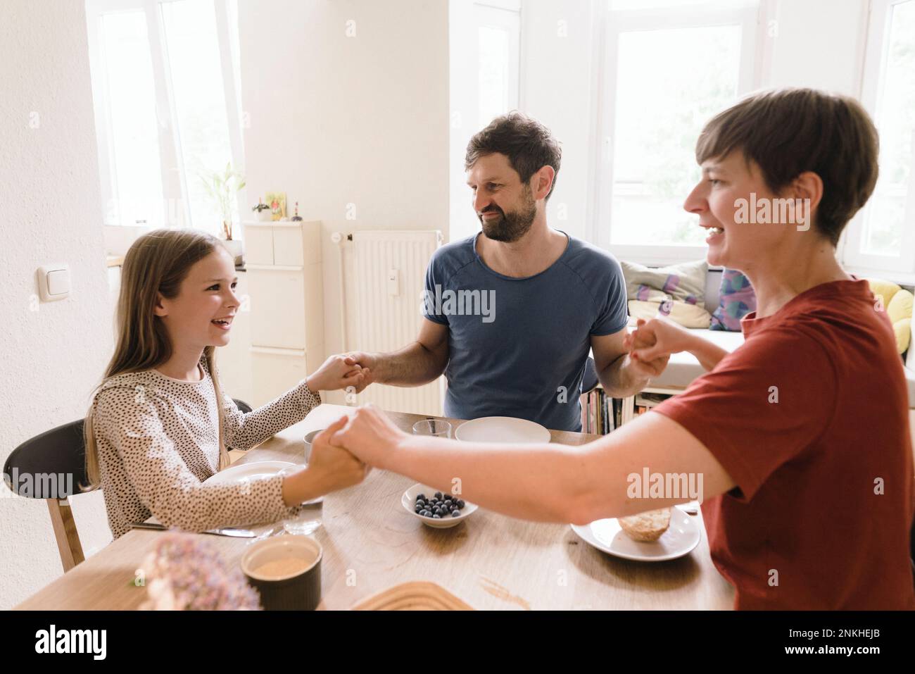 Family praying dining table hi-res stock photography and images - Alamy