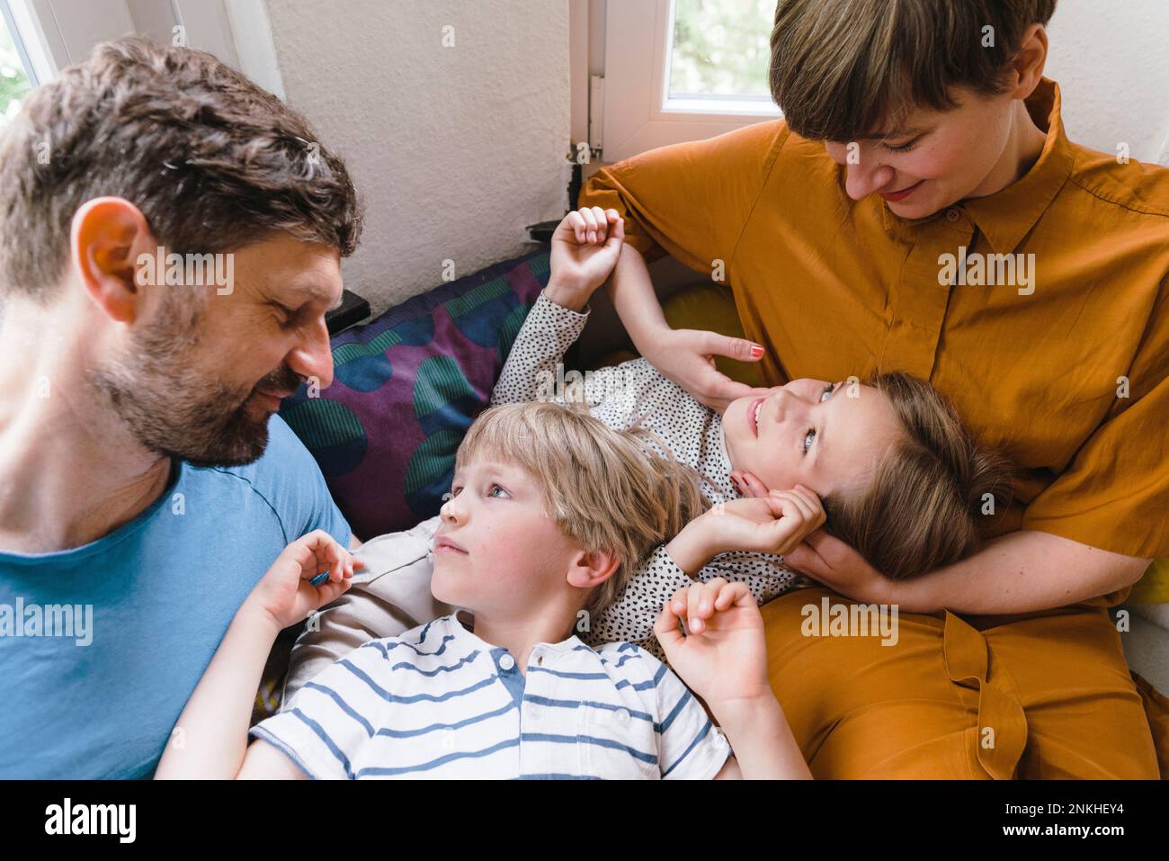 Son and daughter spending leisure time with parents at home Stock Photo