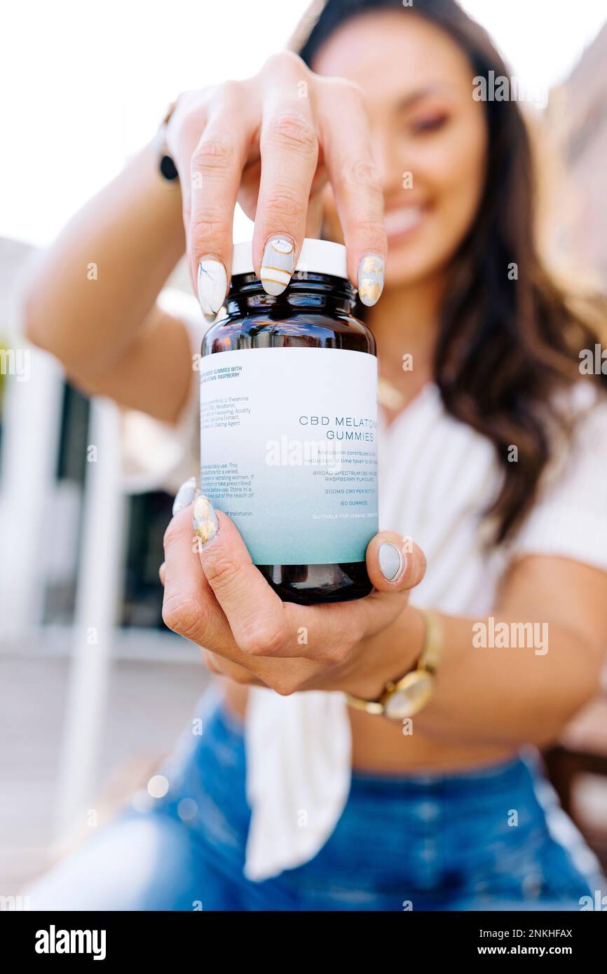 Woman opening lid of medicine bottle Stock Photo Alamy