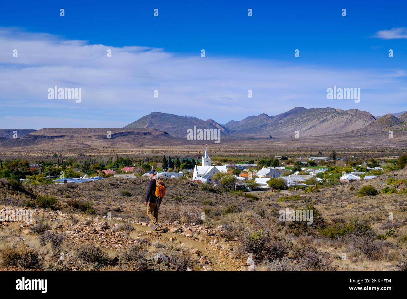 South Africa, Western Cape Province, Prince Albert, Hiker following footpath in front of desert town in Great Karoo Stock Photo