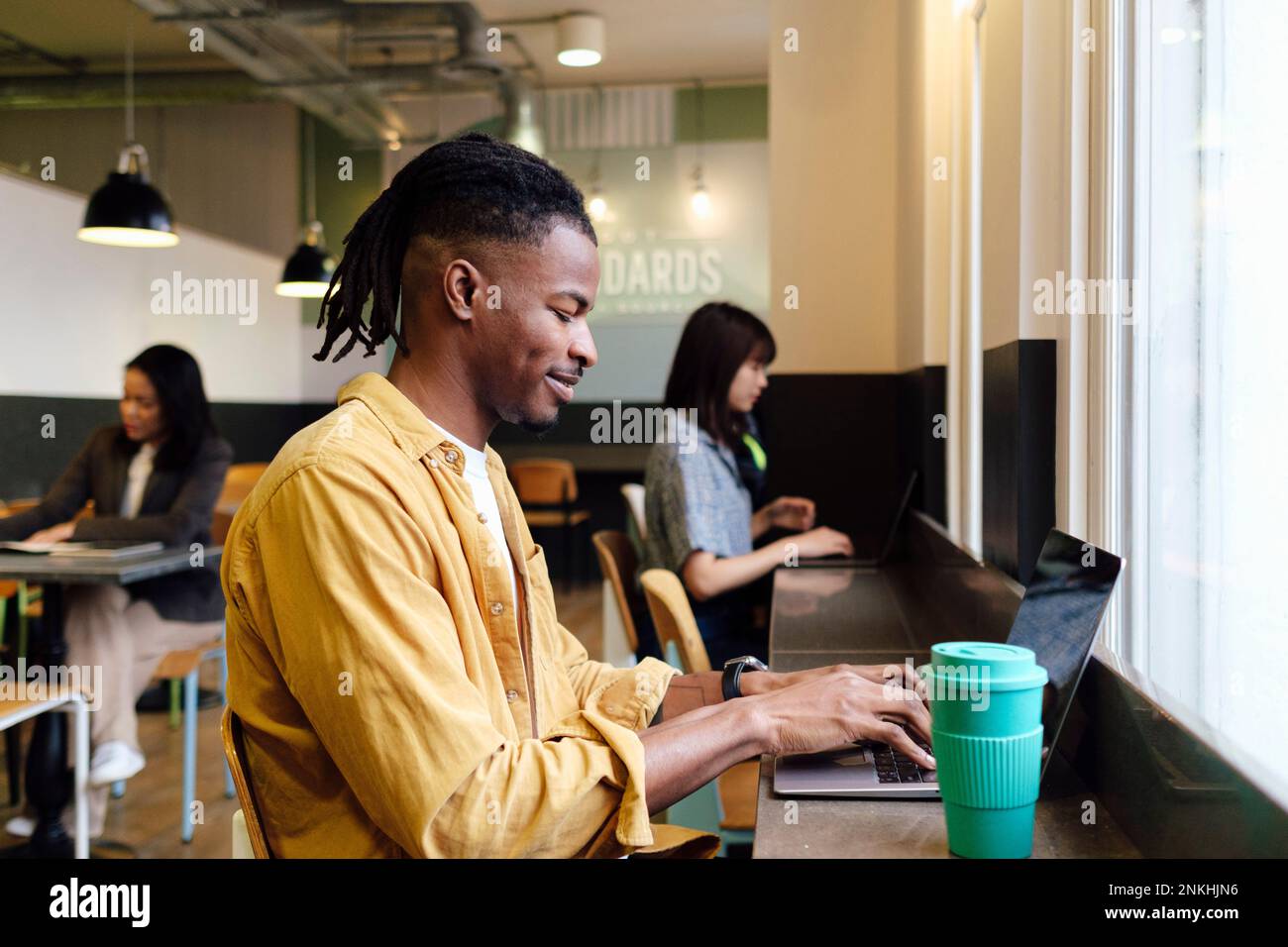 Businessman using laptop sitting at workplace Stock Photo