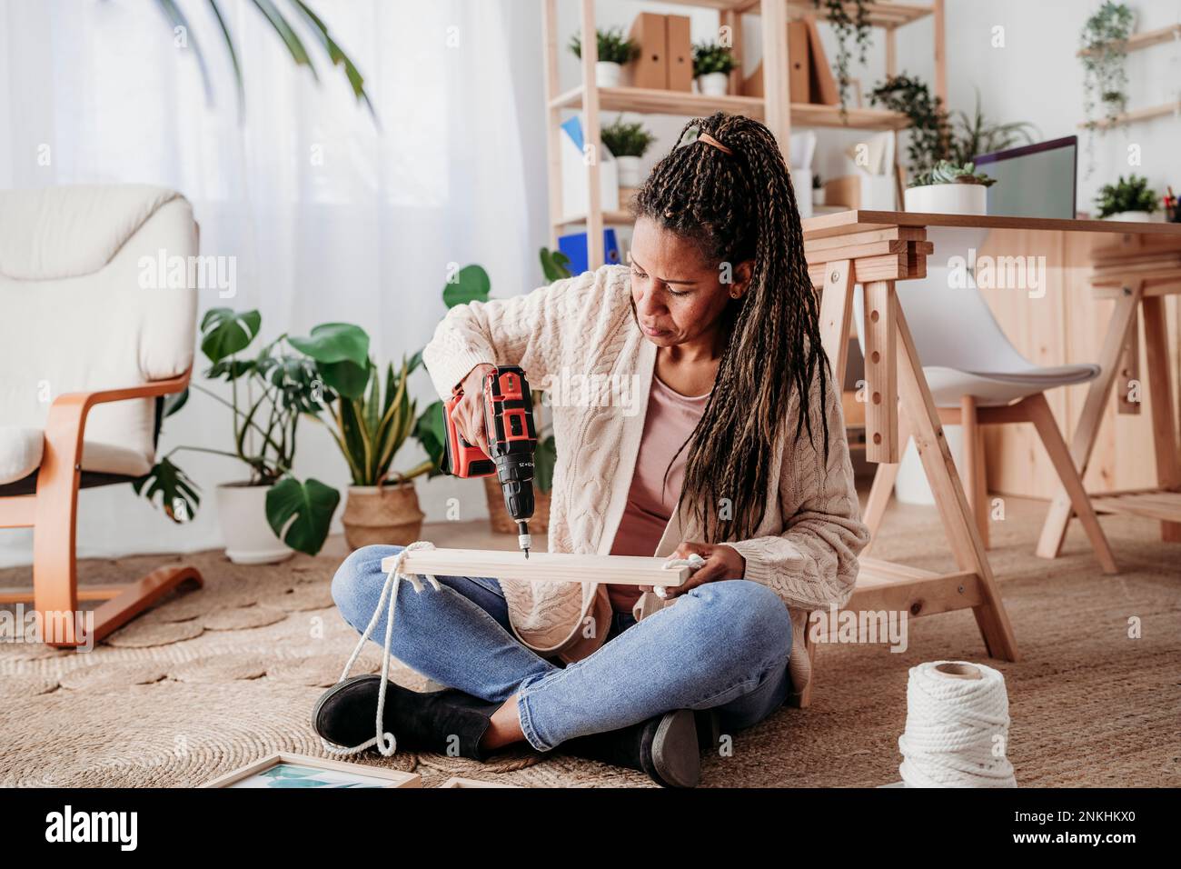 Mature woman making DIY shelf at home Stock Photo Alamy