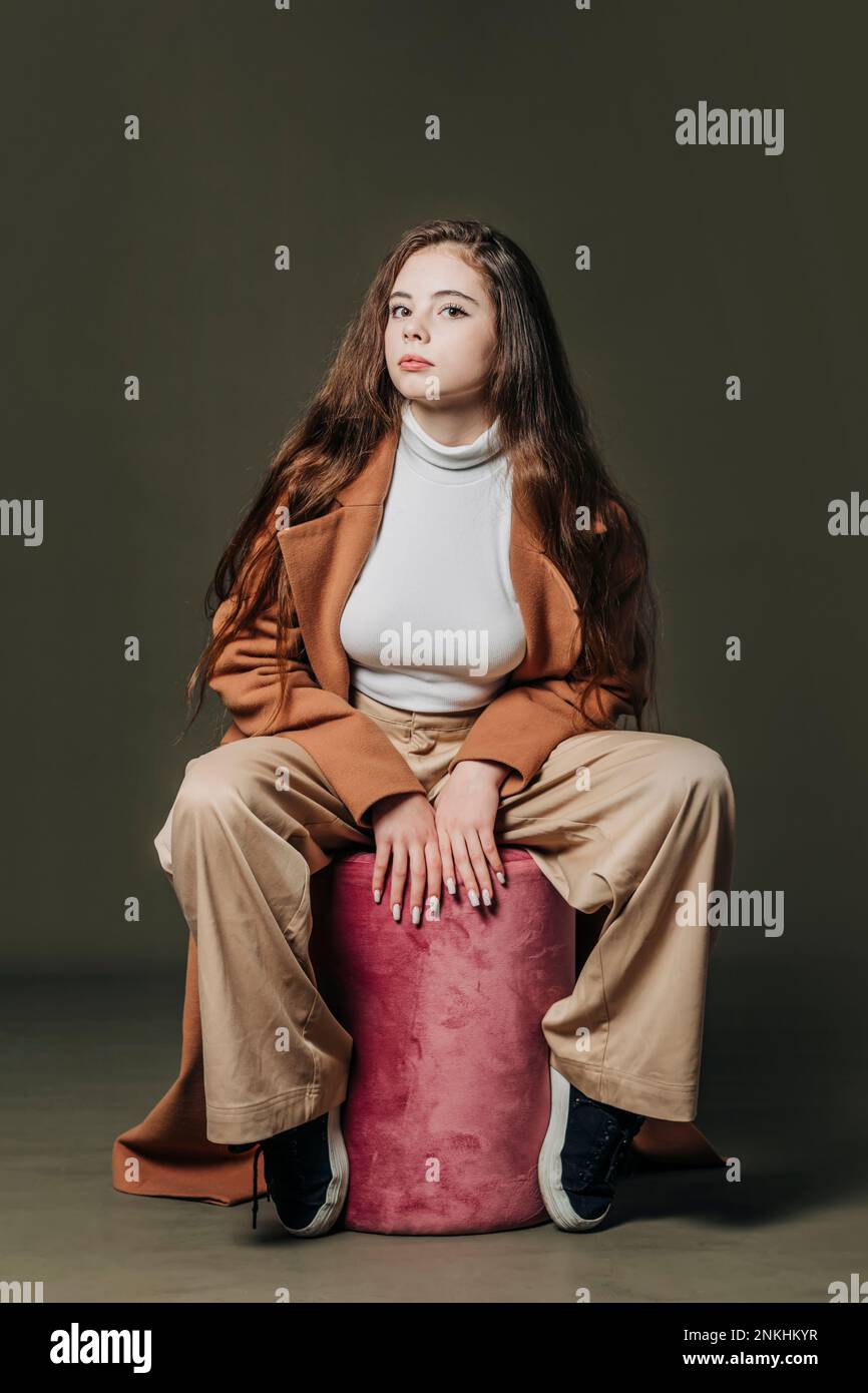 Girl sitting on stool hi-res stock photography and images - Alamy