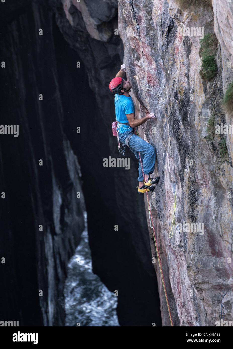 Determined rock climber on mountain Stock Photo