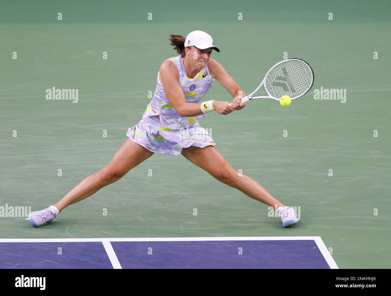 March 18, 2022 Iga Swiatek of Poland returns a shot against Simona Halep of Romania in their semifinal match of the 2022 BNP Paribas Open at Indian Wells Tennis Garden in Indian