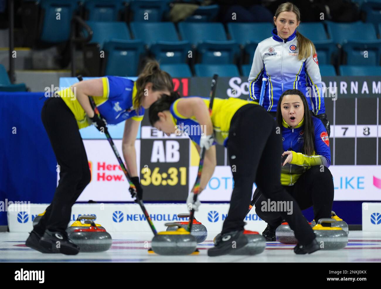 Alberta skip Kayla Skrlik, right, calls out to the sweepers as British Columbia skip Clancy Grandy, back right, watches during the Scotties Tournament of Hearts curling event Thursday, Feb