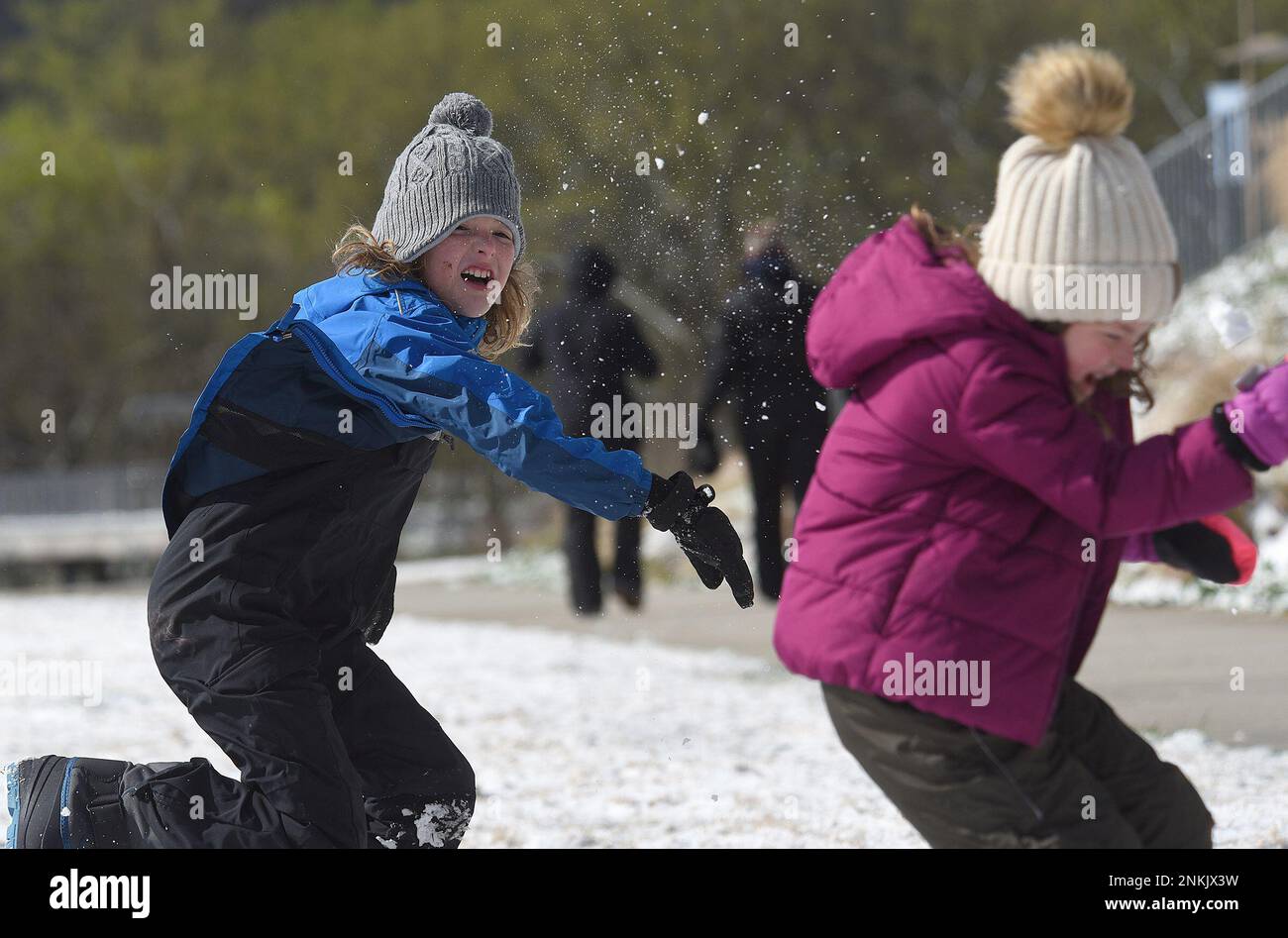 Ian Mattson, 9, throws a snowball at his sister Elise, 5, as they play in  Renaissance