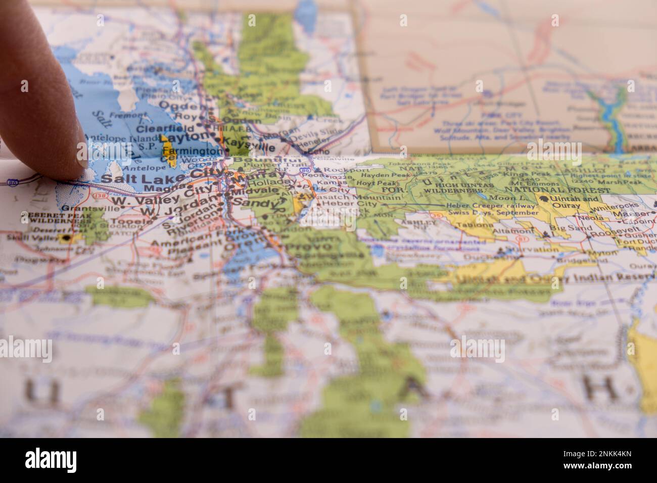 Close up of finger pointing to Salt Lake City, Utah on detailed