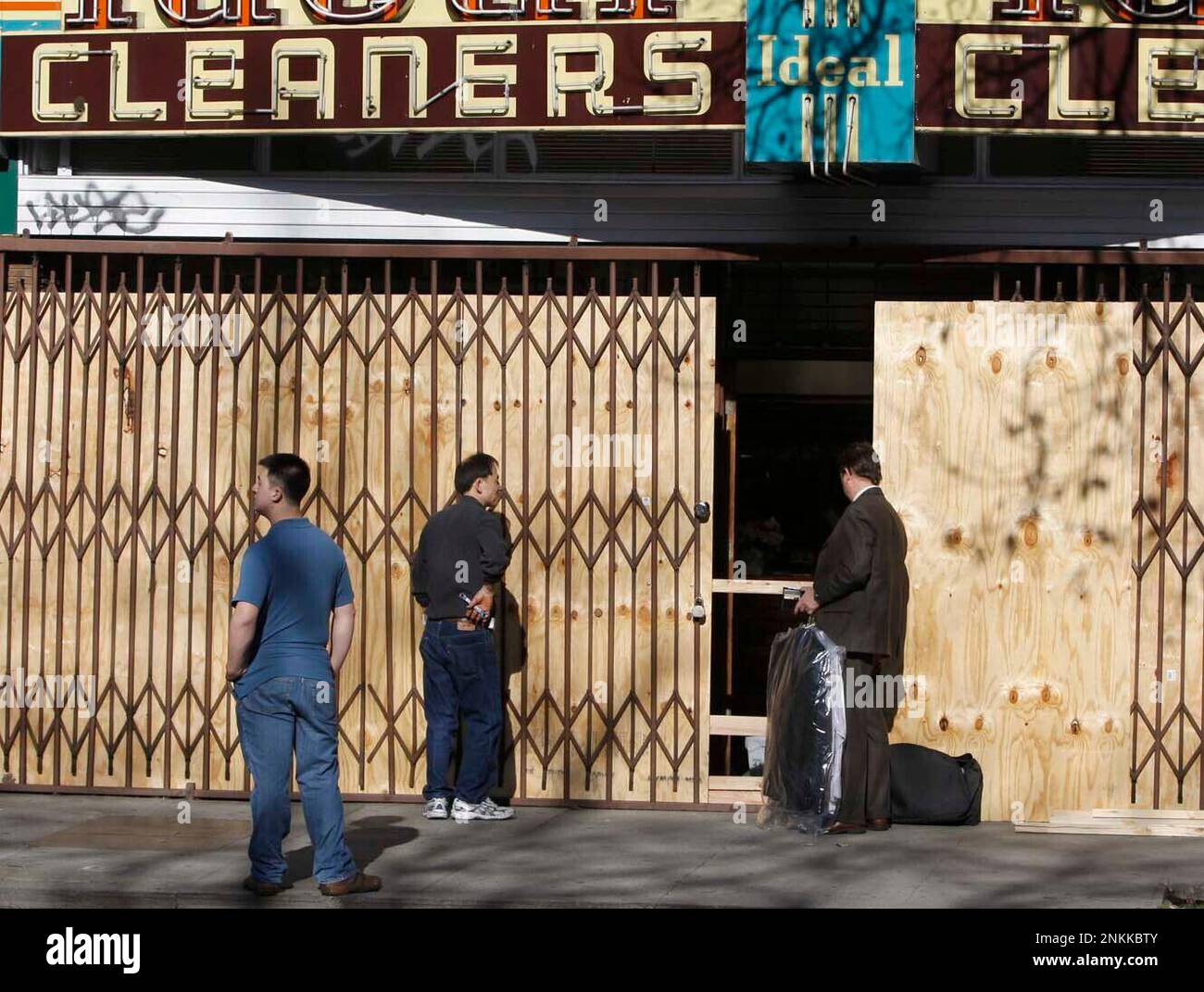 An unidentified customer picks up his dry cleaning from Ideal Cleaners