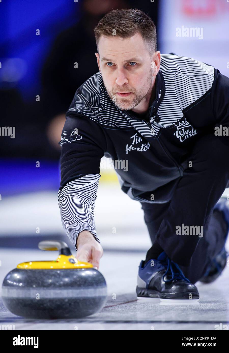Team Wild Card One skip Brad Gushue makes a shot while playing Team